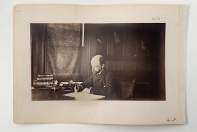 Henry Adams seated at a desk by American Photographer